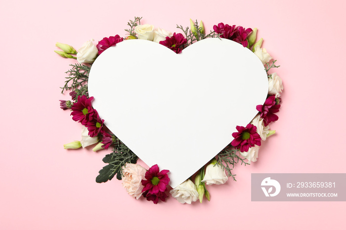 Blank heart and different flowers on pink background, space for text