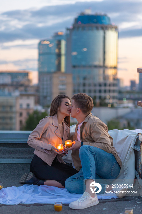 Beautiful young loving couple on a surprise date on a Saint Valentines Day on a rooftop. Romantic p