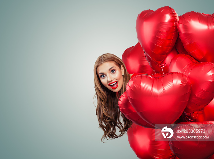 Happy surprised woman withred balloons. Perfect smiling girl with red lips makeup portrait. Surprise