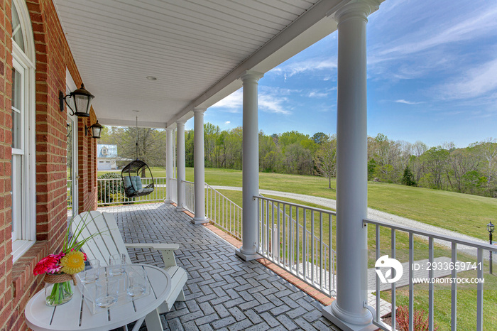 Covered Porch with tile floor patio furniture handing chair