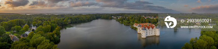 Panorama aerial view of water castle Glücksburg on the Flensburg Fjord in the town of Glücksburg, Schleswig-Holstein, Germany. Renaissance castle at the lake in Glucksburg.