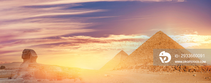 Pyramids of Giza in Cairo Egypt and Sphinx dramatic sunset sky. Banner travel Egyptian