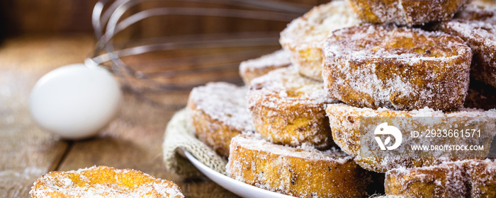 Brazilian dessert french toast for Christmas on rustic wooden background. Selective focus.