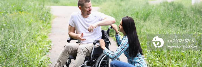 Young woman comforting husband in wheelchair, support in recovery