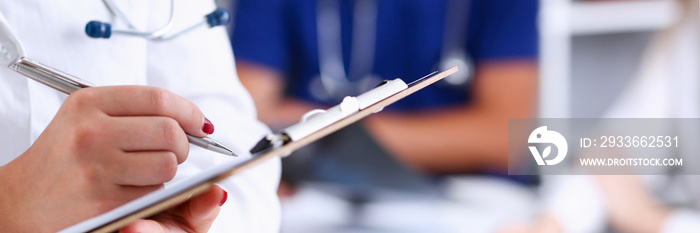 Female doctor hold clipboard pad and fill medical history