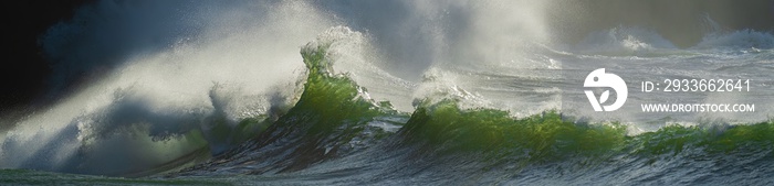 Huge wave crashing against a headland on the South Washington State  coast during a king tide