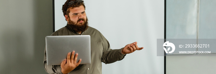 Portrait of happy teacher standing in classroom