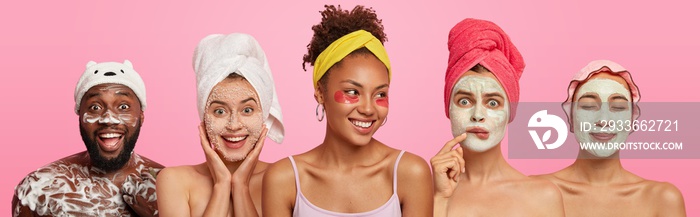 Joyful optimistic three women enjoy beauty treatments in spa salon, positive bearded dark skinned man washes with shower gel, express good emotions, stand in one row, isolated over pink background