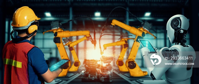 Mechanized industry robot and human worker working together in future factory . Concept of artificial intelligence for industrial revolution and automation manufacturing process .