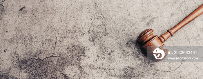 Wooden judge gavel on gray stone background, banner law concept