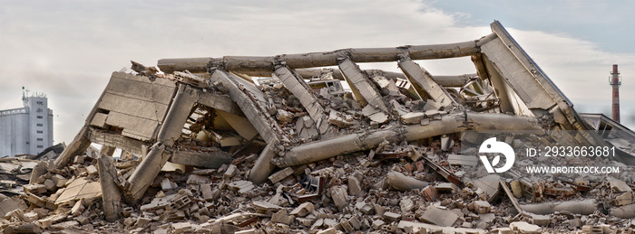 Collapsed concrete industrial building isolated on white background with factory chimney and another concrete building in background. Disaster scene full of debris, dust and damaged house