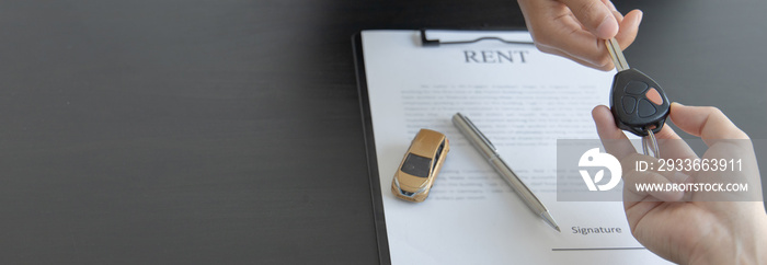 Car salesman gave the keys to the customers who signed the purchase contract legally, Successful completion of car sales, Purchase contract and key delivery.