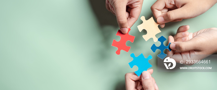 Color puzzle symbol of awareness for autism spectrum disorder family support. Father, Mother, Children holding jigsaw puzzle Autism World Awareness Day.