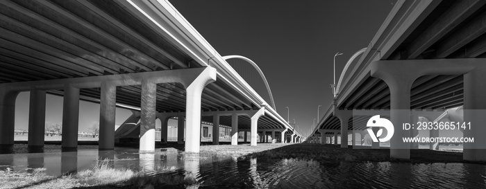 Monochromatic abstract geometry of the underside of Margaret McDermott Bridge over Trinity River at Trinity Skyline Trail Park in Dallas, Texas, USA