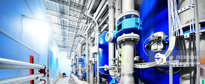 Large blue tanks in a industrial city water treatment boiler room. Wide angle perspective