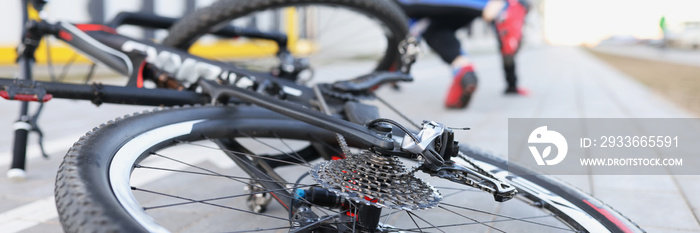 Man in sports uniform falling from bicycle closeup