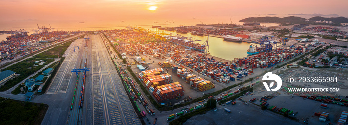 The International cargo container depot at sunset , multiple supply chain truck train and cargo ship working service shipping and transportation concept logistic and transport.