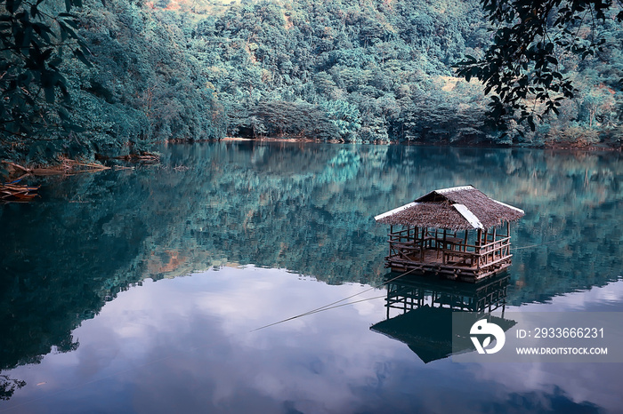 landscape on the lake, philippine islands / tropical volcano lake with a floating house