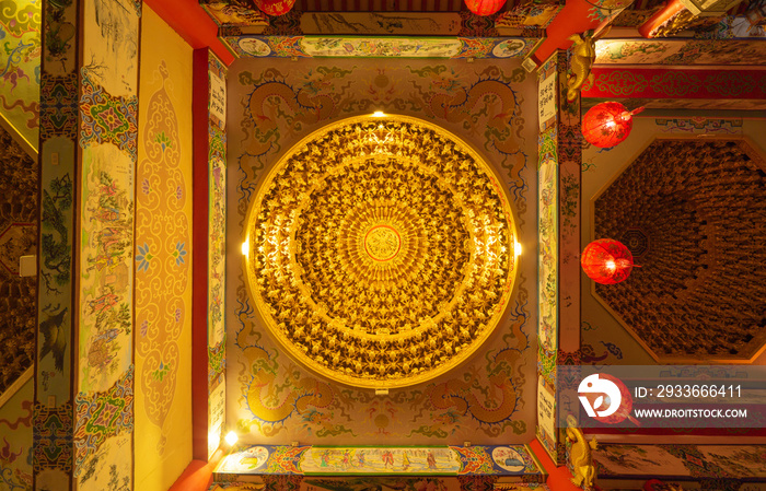 Bottom view of golden chandelier hanging ceiling golden light with red lamp lanterns in Chinese temple. Circle square frame. Decoration painting.