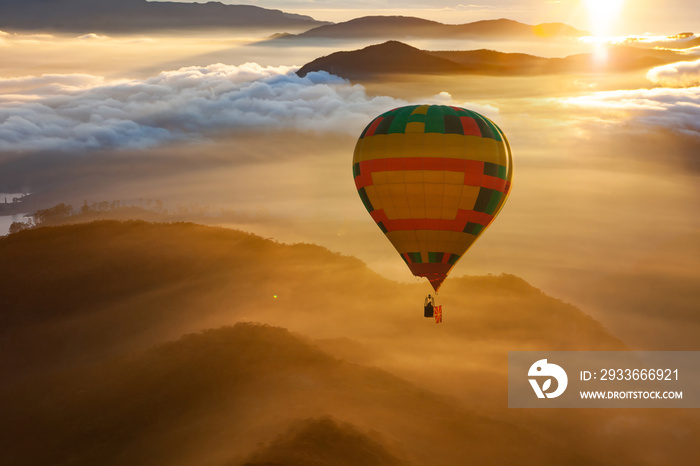 hot air balloon flying over misty mountains at sunrise - freedom and travel concept