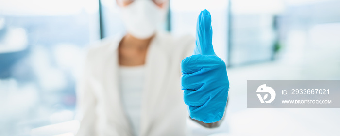 Coronavirus success happy news lab researcher doing thumbs up with medical gloves for vaccine. PPE for COVID-19 healthcare banner panoramic.