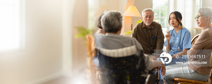 Group of asian senior people listening to young nurse. Psychological support group for elderly and lonely people in a community centre. Group therapy in session sitting in a circle in a nursing home.