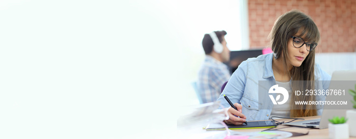 Young woman working with graphic tablet in office, template