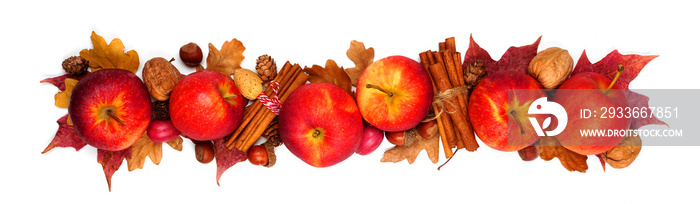 Autumn border of apples, leaves, and fall decor. Above view isolated on a white background.