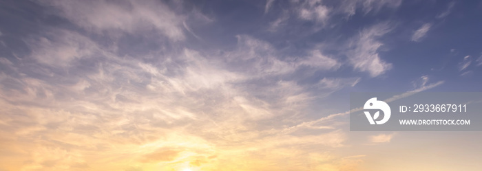 Colorful dramatic clouds lit by a sun against the sunset or sunrise sky.