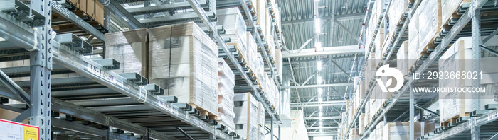 Rows of shelves with boxes in modern warehouse