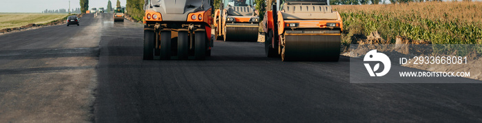 Vibratory asphalt roller compactor compacting new asphalt pavement. Road service repairs the highway