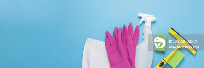 Cleaning and cleaning accessories, Gloves, spray, sponges, scraper for windows on a blue background. Cleaning Service Concept. Banner. Copy space. Flat lay, Top view