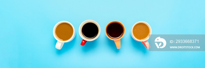 Cups with hot drinks, coffee, cappuccino, coffee with milk on a blue background. Concept coffee shop, meeting friends, breakfast with friends, friendly team. Banner. Flat lay, top view