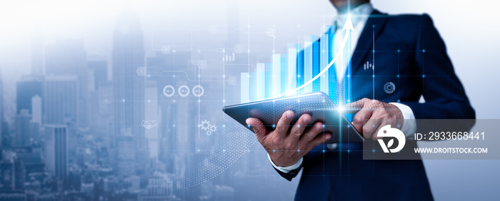 A businessman looks over sales figures and a 3D graph of economic growth. This is a business plan. The abstract icon. The usage of digital marketing is referred to as