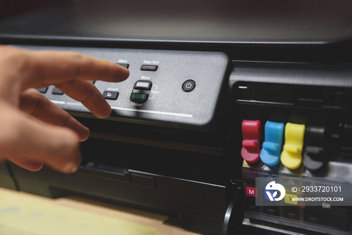 Copier concept - Business man hand press button on panel on printer ink for scanner copy machine sup