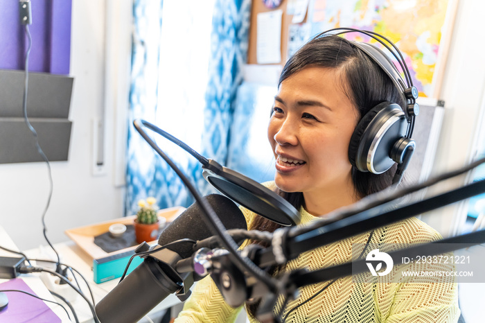 Smiling asian woman Speaks to Microphones, Broadcasting Program on Air