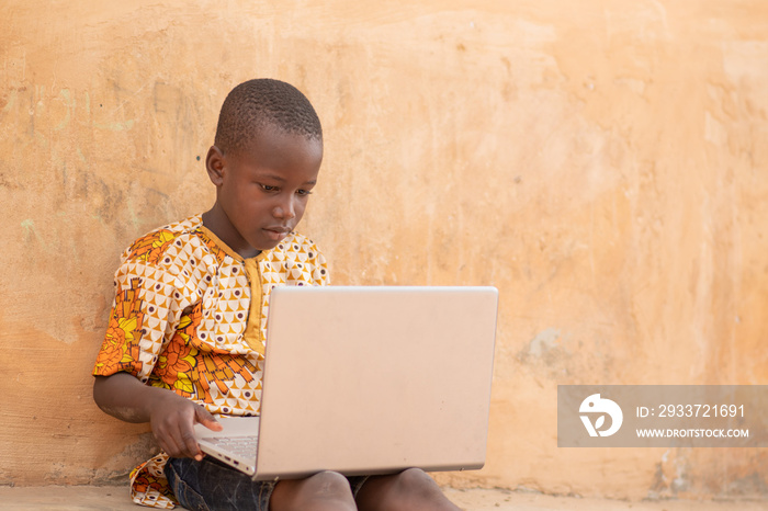 african child using a laptop computer