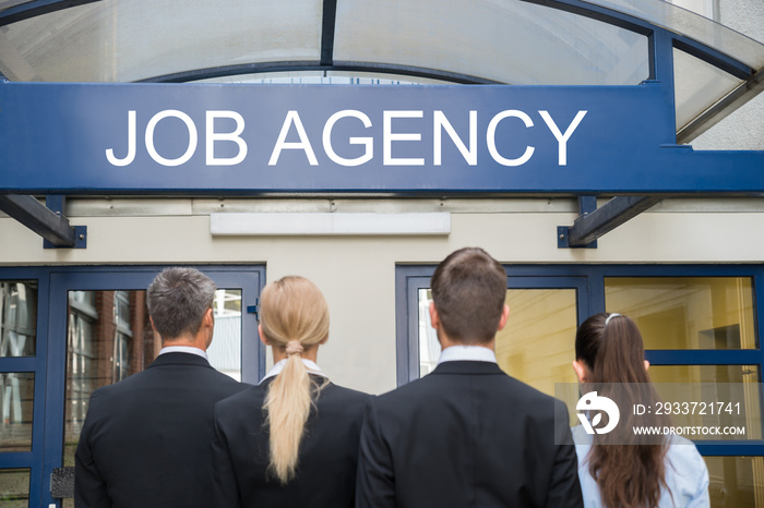 Businesspeople Standing Outside Job Agency