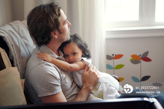 Father with his daughter sitting at home