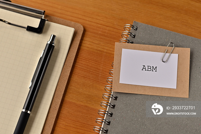 There is a piece of paper with the word ABM written on it. It was an abbreviation for Account Based 