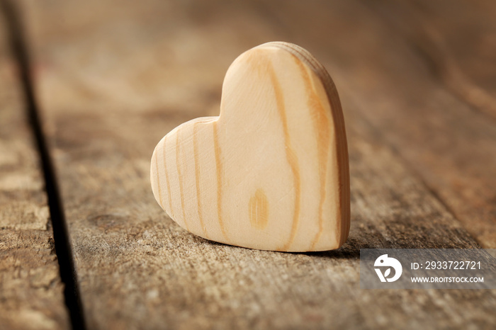 Wooden heart on rustic wooden background