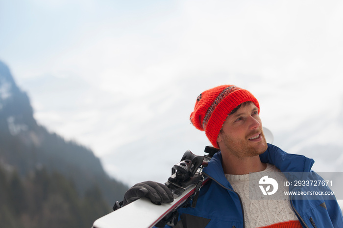 Man carrying skis