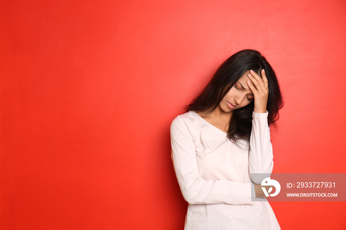 Stressed young woman on color background