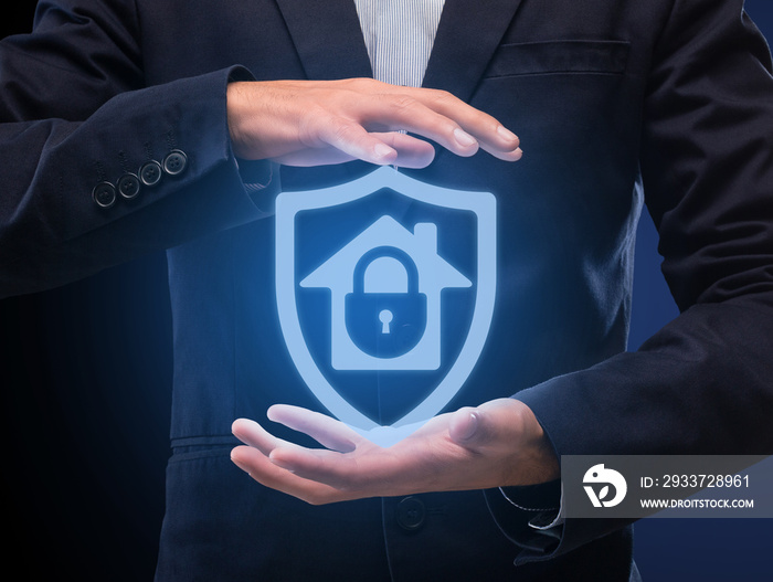 Man in suit holding hologram of locked house in hands