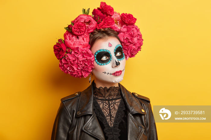 Horizontal shot of scary woman with painted lips and dark circles around eyes looks away has image o