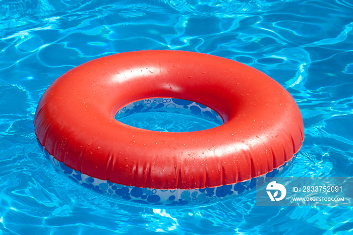 Inflatable red swim ring on blue pool