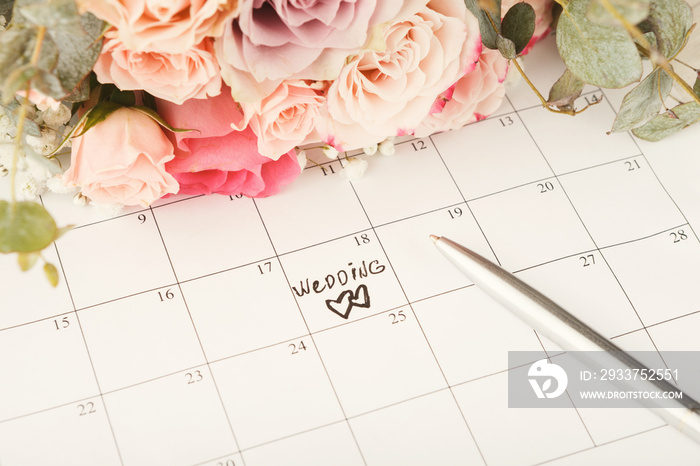 Word wedding on calendar with sweet flowers