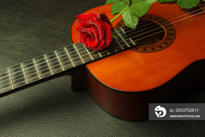 Classical Spanish guitar and red rose