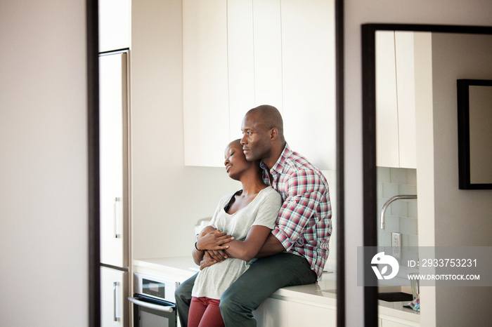 Couple embracing at home