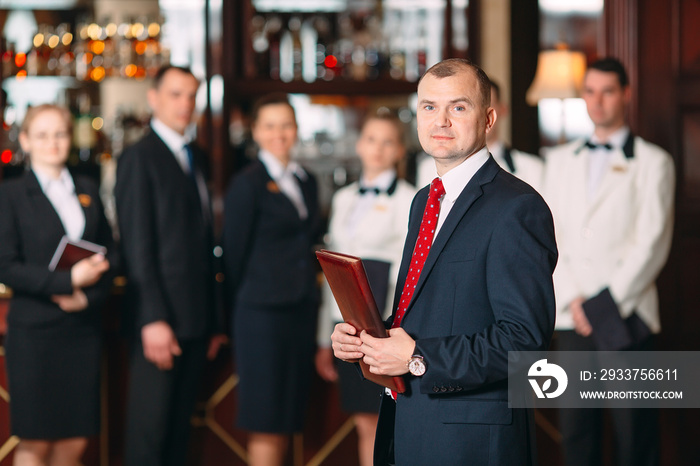 The interaction of the staff. Hotel or restaurant manager and his staff in kitchen. interacting to h